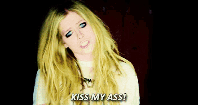 a woman with blonde hair and blue eyes is saying kiss my ass