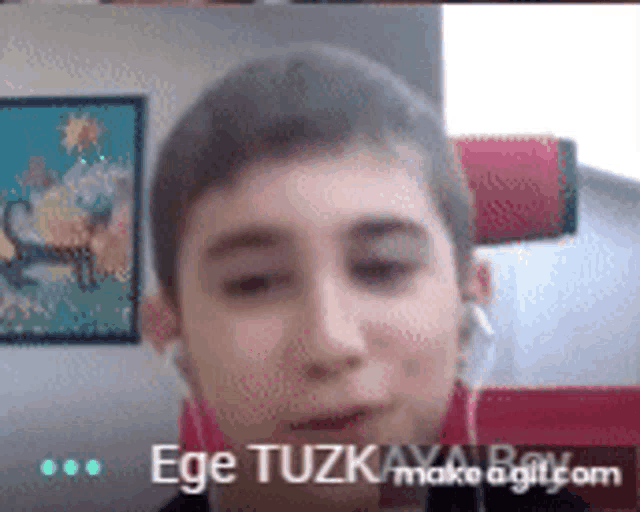 a close up of a person 's face with the name ege tuzk written on the bottom