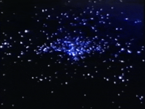 a blue glowing object in the middle of a black background