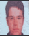 a blurry picture of a young man 's face with a blue background .