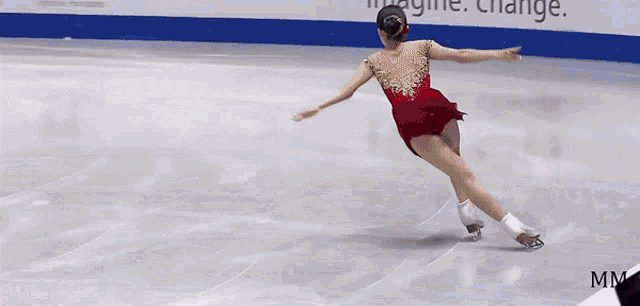 a woman in a red dress is skating on a rink with ads ctv tsn