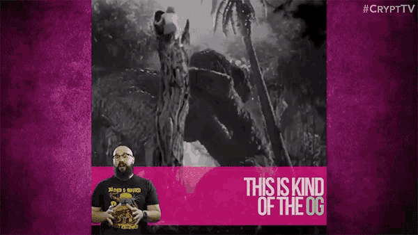 a man with a beard stands in front of a screen that says " this is kind of the og "