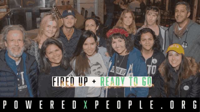 a group of people posing for a photo with the words fired up + ready to go behind them