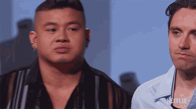 two men are standing next to each other with the word netflix on the bottom right