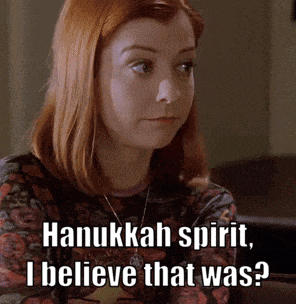 a woman with red hair is wearing a shirt that says hanukkah spirit , i believe that was ?