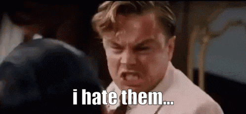 a man in a suit and tie is making a funny face and saying `` i hate them ... ''