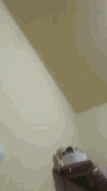a corner of a room with a white wall and a box on top of it