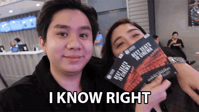 a man and a woman are posing for a picture and the woman is holding a ticket that says i know right