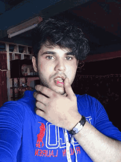 a man wearing a blue shirt that says u.s. polo on it
