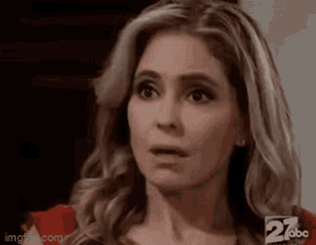 a close up of a woman 's face with a surprised expression .