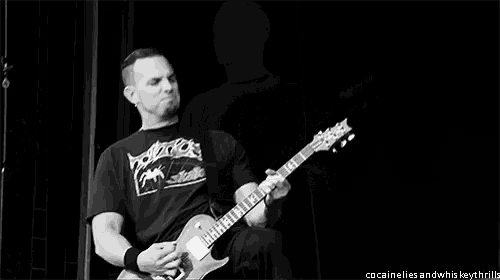 a man playing a guitar in a black and white photo with the words cocainelles and whiskeythrills at the bottom