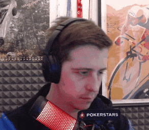 a man wearing headphones and a microphone that says pokerstars on it