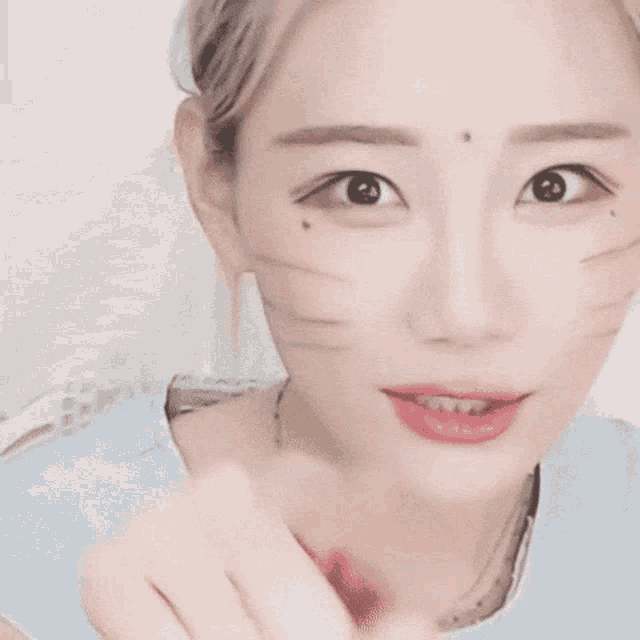 a close up of a woman 's face with cat whiskers on her face