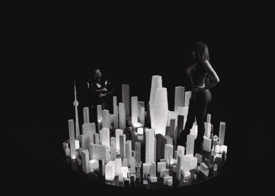 a black and white photo of a city with a man and woman