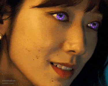 a close up of a woman 's face with purple eyes and xiaolanhua tumblr.com written below it
