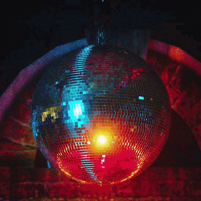 a disco ball hanging from the ceiling with a light inside of it