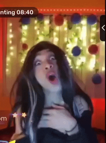 a woman is making a funny face in front of a screen that says ' nting 8:40 '