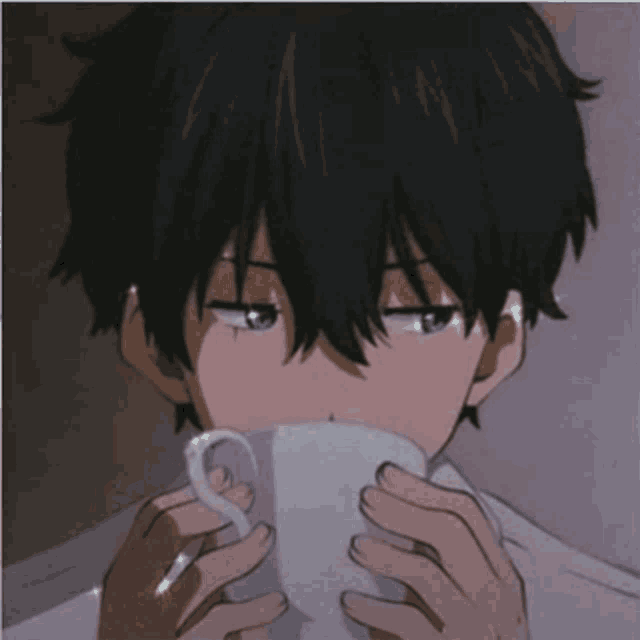 a boy with black hair is drinking from a cup .
