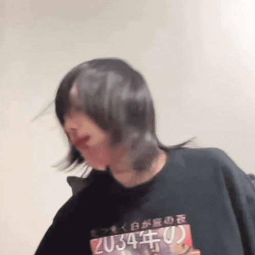 a woman wearing a black shirt that says 2034