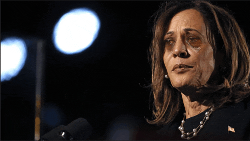 a woman with tears coming out of her eyes is speaking into a microphone