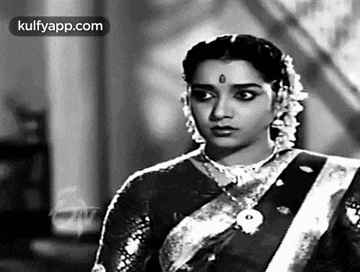 a black and white photo of a woman in a saree