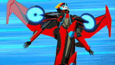 a red and black robot with wings is flying in the sky .