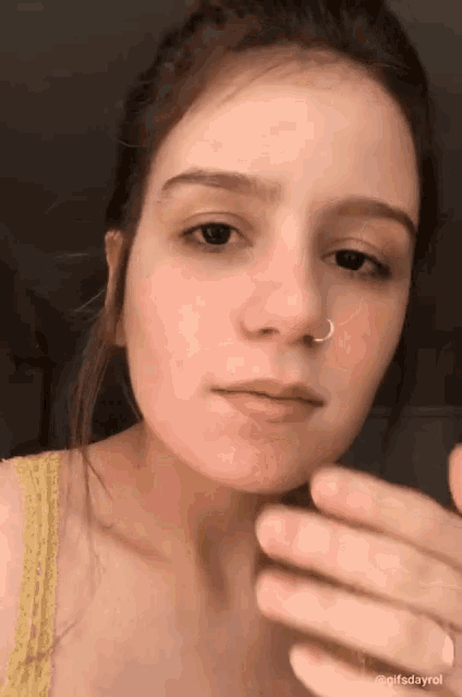 a woman with a nose ring on her nose