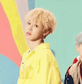 a young boy wearing a yellow jacket and a yellow shirt is dancing .