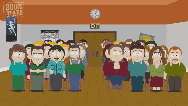 a group of people sitting in front of a south park sign