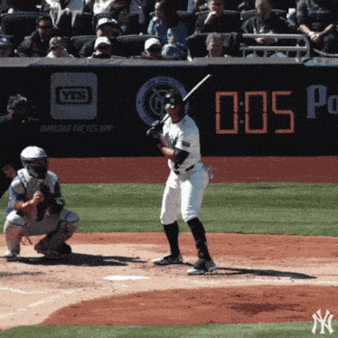 a new york yankees baseball player getting ready to hit a ball