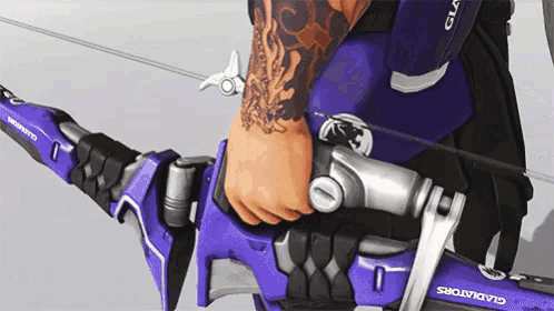 a person with a tattoo on their arm is holding a purple gladiator bow