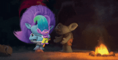 two trolls standing next to each other in front of a campfire