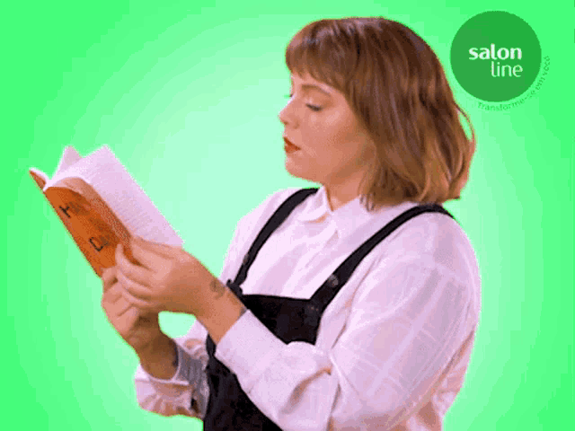 a woman is reading a book with a green circle that says salon line on it