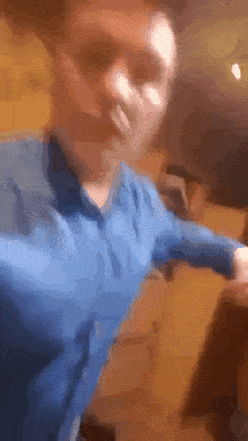 a blurry picture of a man in a blue shirt dancing
