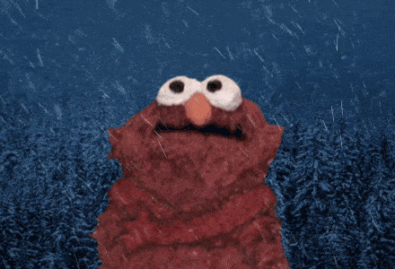 elmo is standing in the rain looking up at the sky