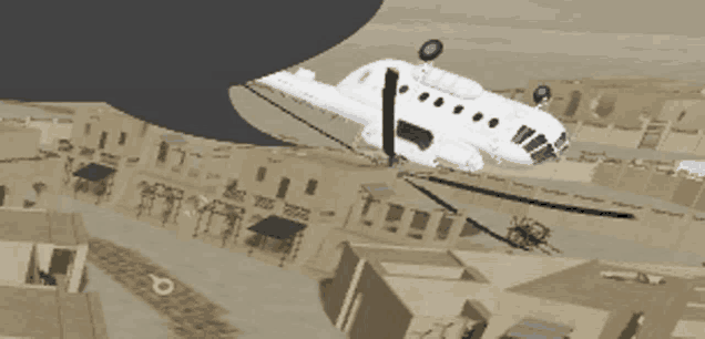 a white airplane is flying over a desert town