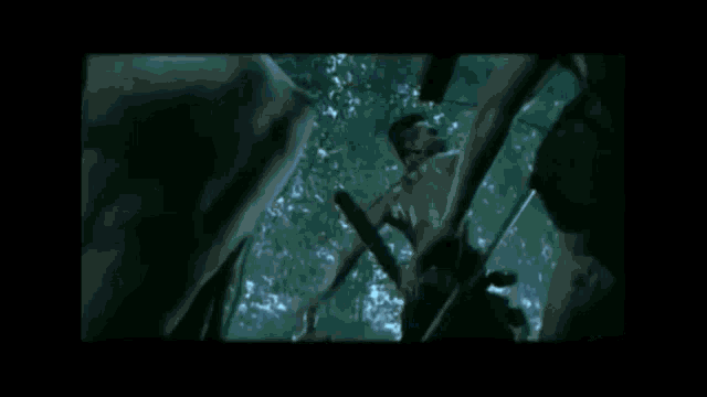 a blurry picture of a skeleton holding a sword .