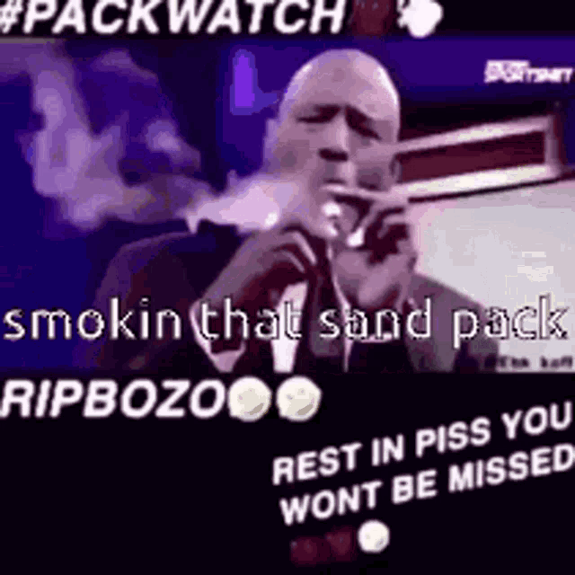 a man in a tuxedo is smoking a cigarette and talking into a microphone .