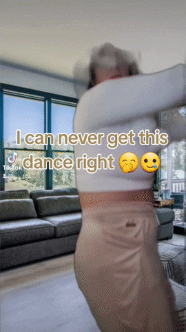 a woman is dancing in a living room with a caption that says i can never get this dance right