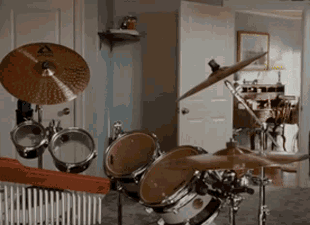 a drum set in a room with a cymbal that says ' sabian ' on it