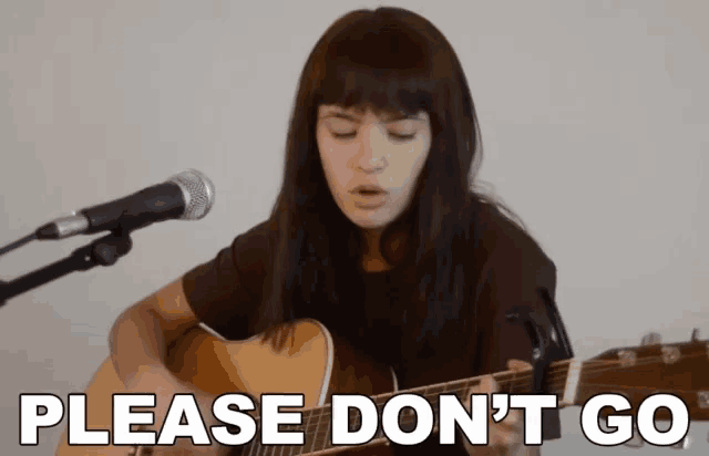 a woman singing into a microphone while playing a guitar with the words please don 't go written on the bottom