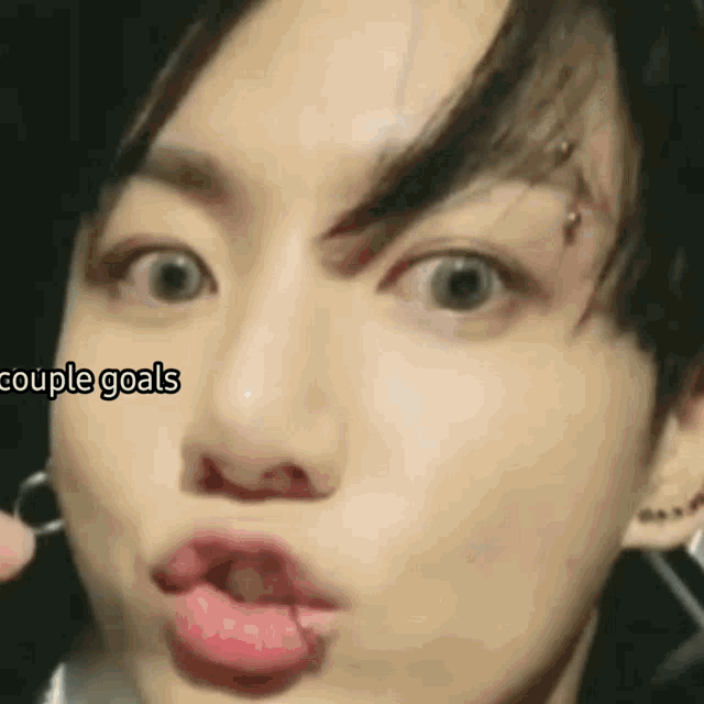 a close up of a person 's face with the words couple goals written on the bottom