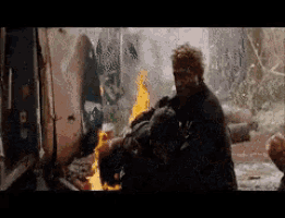 a pixelated image of a man standing in front of a fire