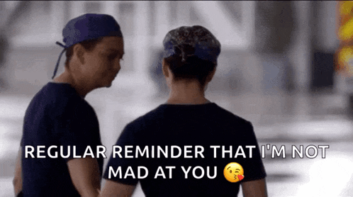 a man and a woman are standing next to each other with the words regular reminder that i 'm not mad at you