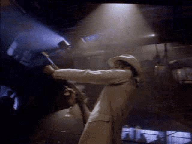 a man in a white hat is holding a microphone