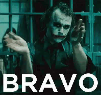 the joker from the movie the dark knight rises is behind bars in a prison cell .