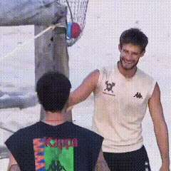 a man in a kappa shirt shakes hands with another man in a black shirt