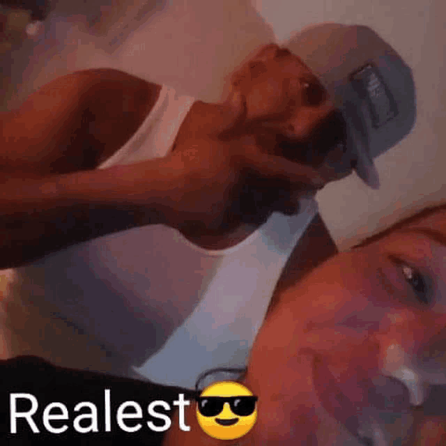 a man and a woman are taking a picture together . the man is wearing a hat and sunglasses .