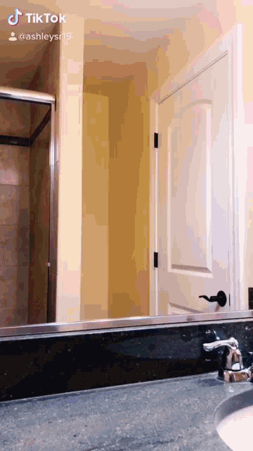 a bathroom with a sink and a mirror with ashleysr19 written on it