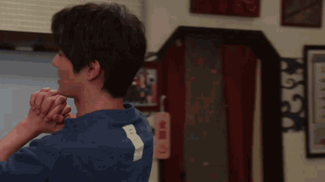 a man in a blue shirt has the number 5 on the back